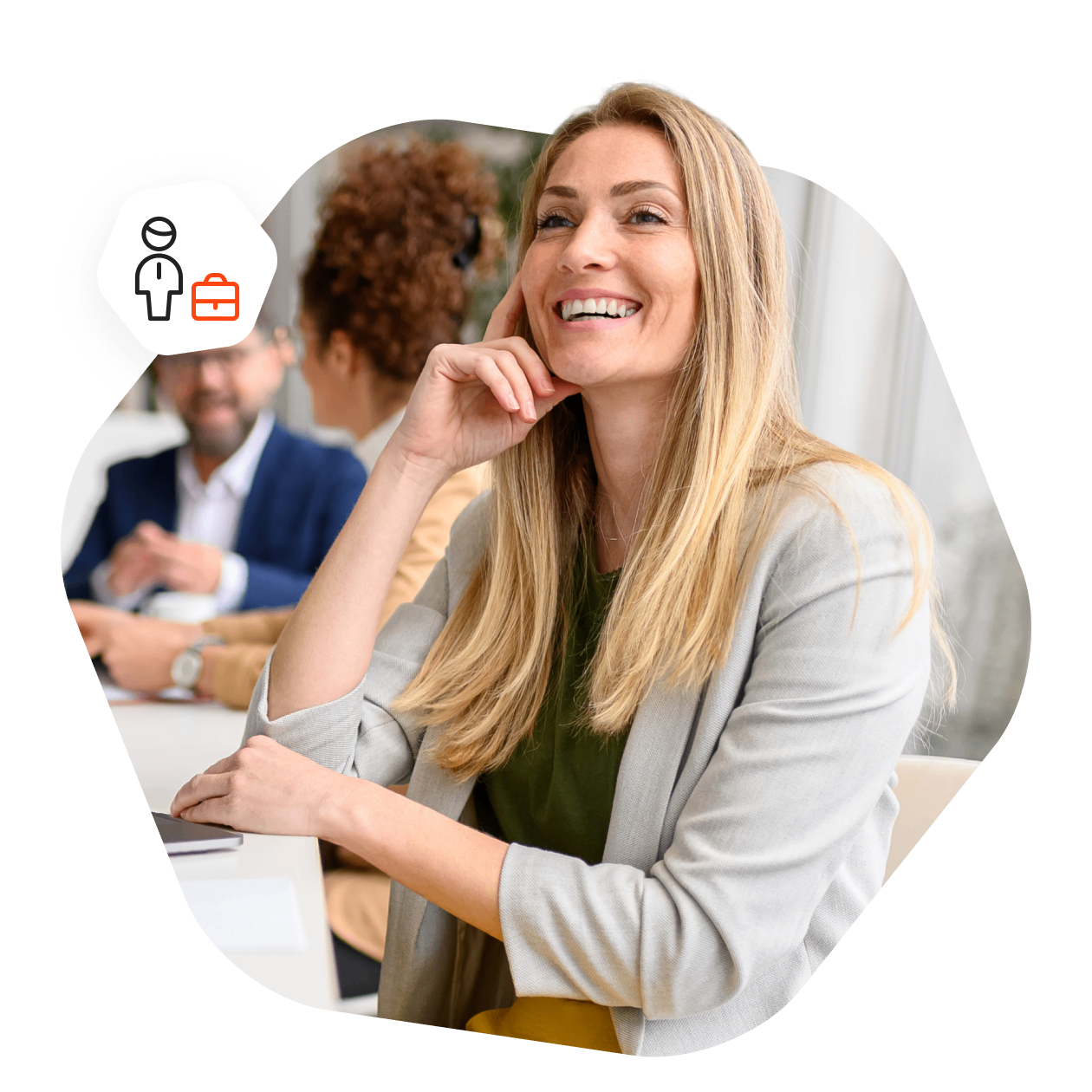 Woman with long blonde hair, sitting at a meeting room table with her laptop in front of her