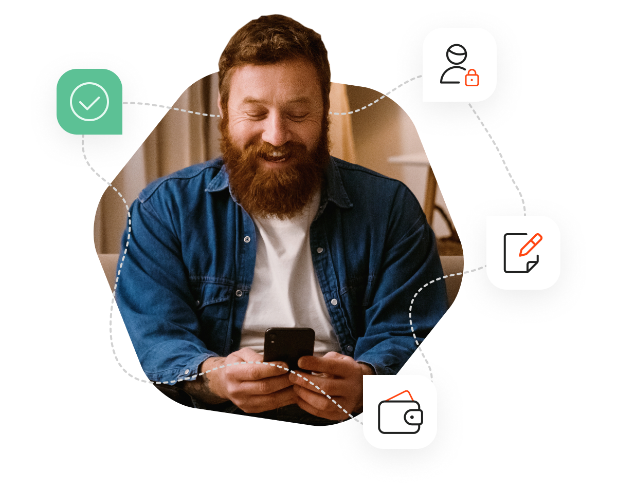 A man with a beard sitting on a couch and looking at his phone