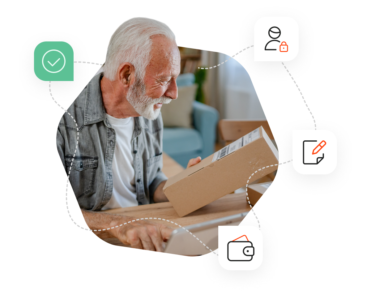 An older man with white hair and beard is holding a parcel and registering it online
