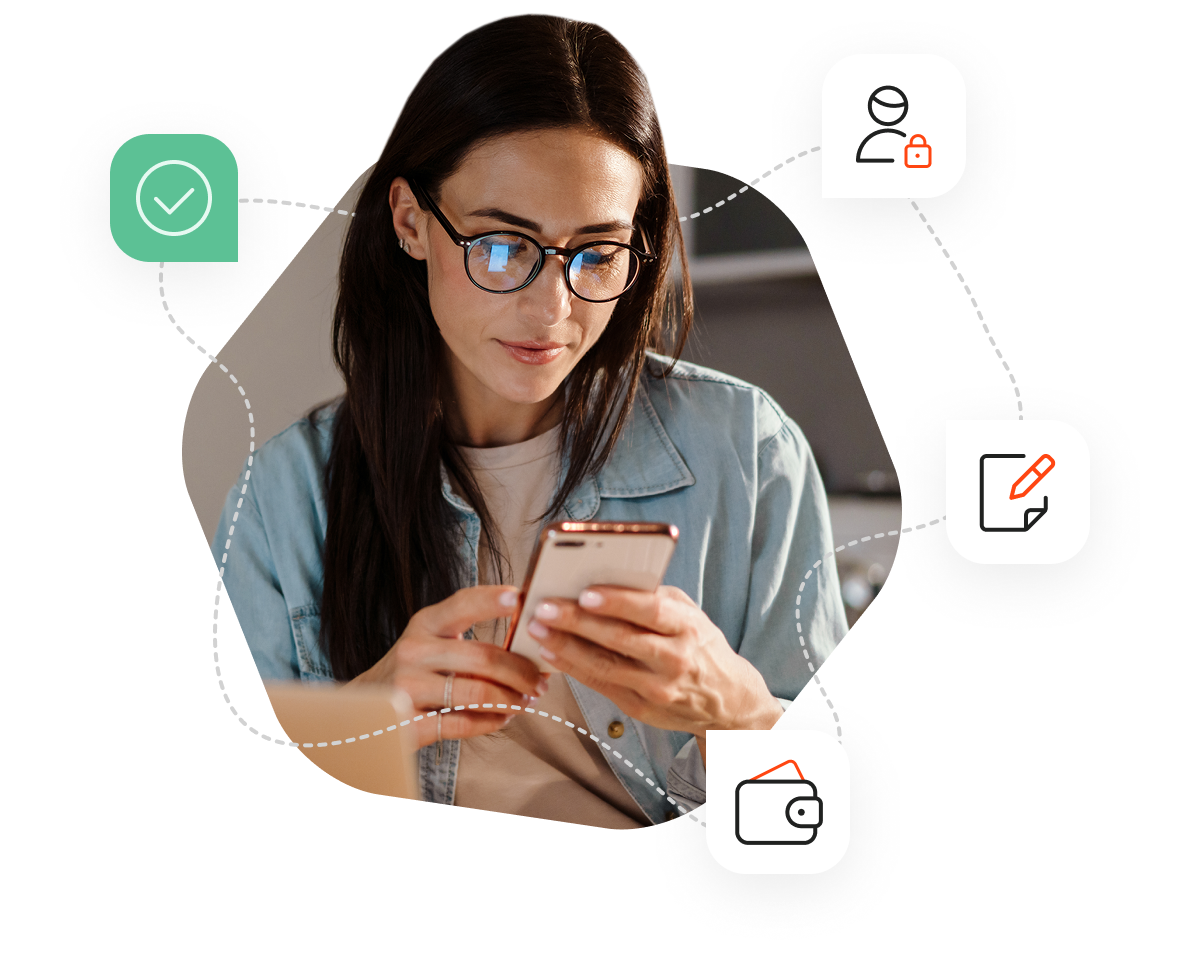 A woman wearing glasses, sitting on her sofa and looking at her phone